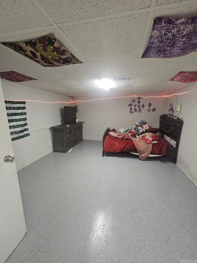 bedroom featuring a drop ceiling and visible vents