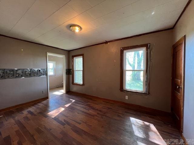 110 Ryerson St, Leachville, AR 72438 - empty room with baseboards, crown molding, and wood finished floors