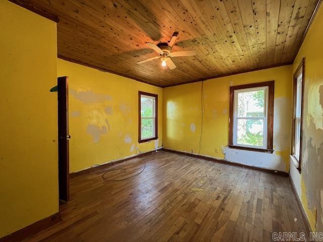 110 Ryerson St, Leachville, AR 72438 - empty room featuring wooden ceiling, ceiling fan, baseboards, and hardwood / wood-style flooring