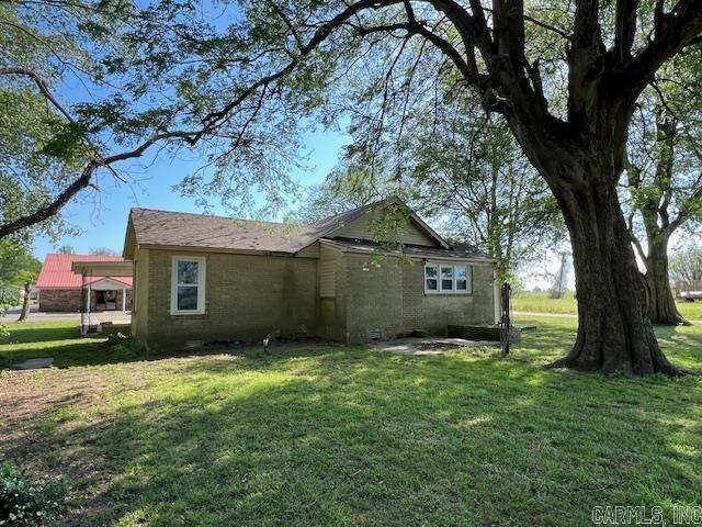 110 Ryerson St, Leachville, AR 72438 - view of side of property with a yard