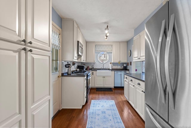 5400 Southwood Rd, Little Rock, AR 72205 - kitchen with a sink, decorative backsplash, dark countertops, and stainless steel appliances