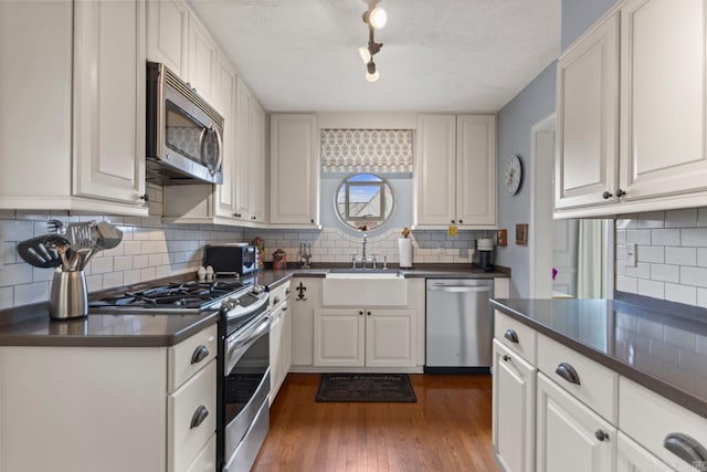 5400 Southwood Rd, Little Rock, AR 72205 - kitchen featuring tasteful backsplash, a sink, dark countertops, and stainless steel appliances