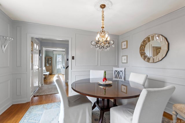 5400 Southwood Rd, Little Rock, AR 72205 - dining room featuring a chandelier, a decorative wall, crown molding, and wood finished floors