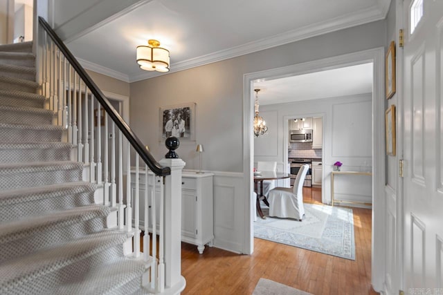 5400 Southwood Rd, Little Rock, AR 72205 - foyer featuring ornamental molding, light wood-type flooring, an inviting chandelier, and stairs