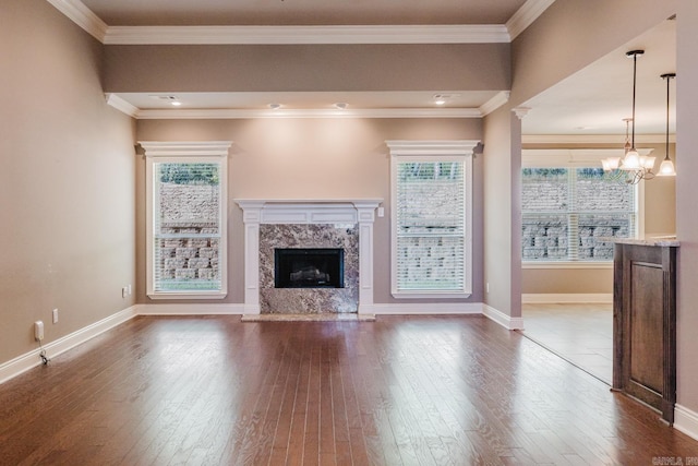 1844 White Oak Cir, Benton, AR 72019 - unfurnished living room featuring a healthy amount of sunlight, an inviting chandelier, a fireplace, and dark wood finished floors