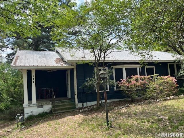 view of front of property with a porch and metal roof