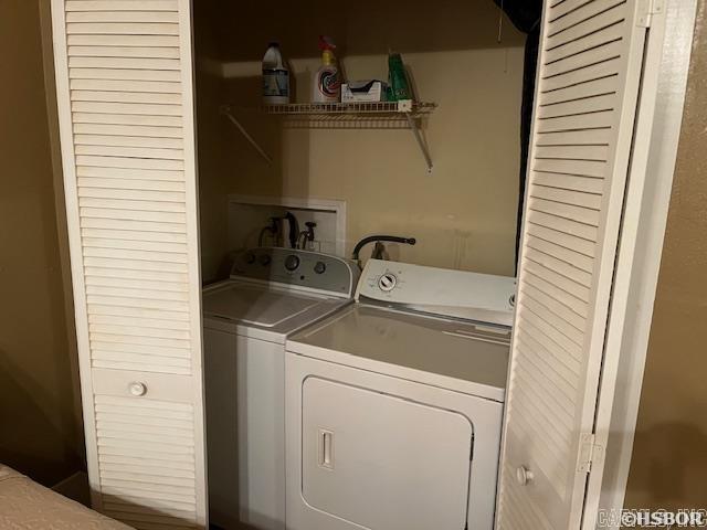 laundry area with washing machine and clothes dryer and laundry area