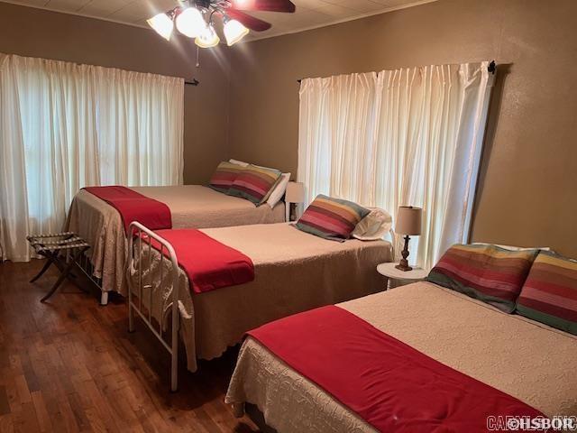 bedroom with ceiling fan and wood finished floors