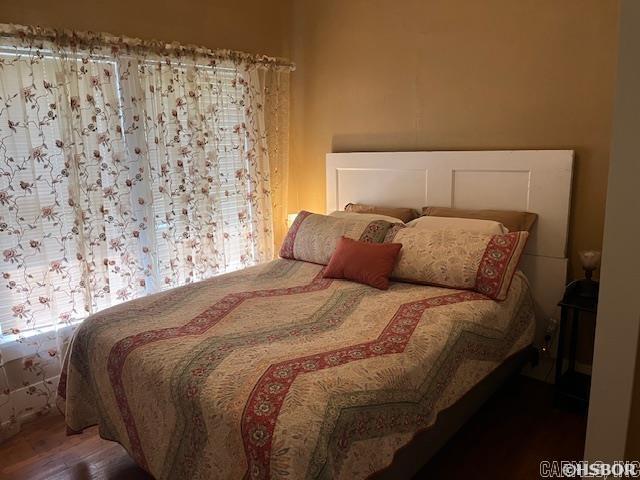 bedroom featuring wood finished floors