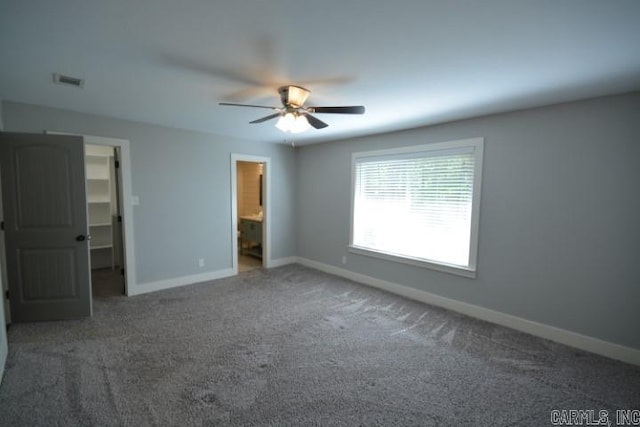 12904 Southridge Dr, Little Rock, AR 72212 - unfurnished bedroom featuring baseboards, a spacious closet, carpet flooring, connected bathroom, and ceiling fan