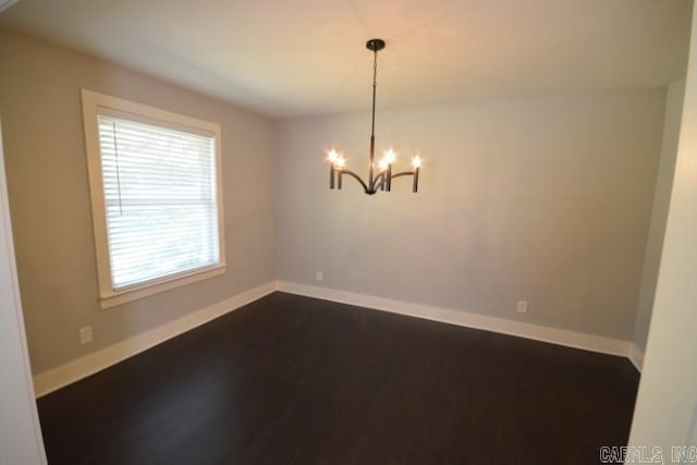 12904 Southridge Dr, Little Rock, AR 72212 - empty room featuring dark wood-type flooring, a chandelier, and baseboards