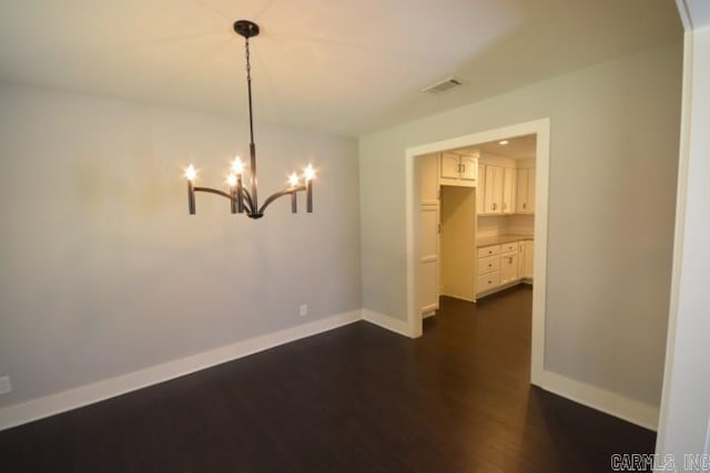 12904 Southridge Dr, Little Rock, AR 72212 - spare room with dark wood-type flooring, a chandelier, baseboards, and arched walkways