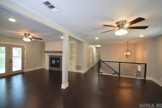 12904 Southridge Dr, Little Rock, AR 72212 - unfurnished living room with ceiling fan, baseboards, recessed lighting, wood finished floors, and a chandelier