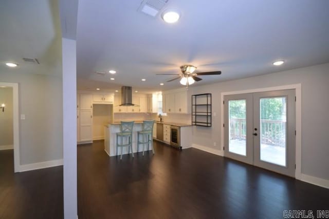 12904 Southridge Dr, Little Rock, AR 72212 - unfurnished living room with french doors, dark wood finished floors, baseboards, wine cooler, and ceiling fan