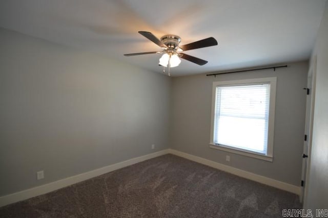12904 Southridge Dr, Little Rock, AR 72212 - spare room with a ceiling fan, dark colored carpet, and baseboards