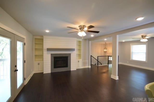 12904 Southridge Dr, Little Rock, AR 72212 - unfurnished living room featuring ceiling fan, dark wood-style floors, baseboards, built in features, and plenty of natural light