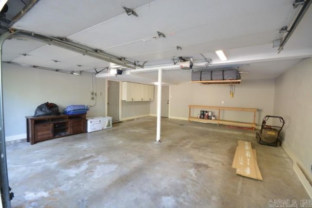 12904 Southridge Dr, Little Rock, AR 72212 - garage with a garage door opener and baseboards