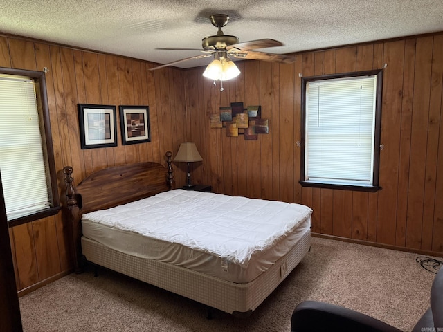 62 Ruby Ln, Melbourne, AR 72556 - carpeted bedroom featuring wood walls, baseboards, a ceiling fan, and a textured ceiling