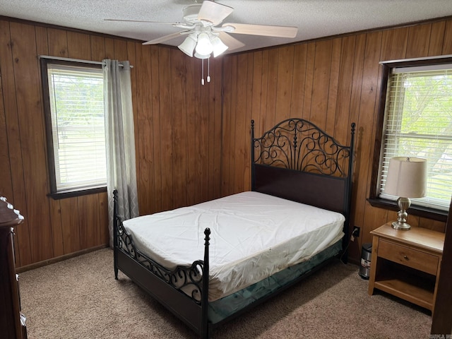 62 Ruby Ln, Melbourne, AR 72556 - bedroom with wood walls, multiple windows, a textured ceiling, and light colored carpet