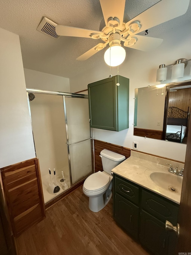 62 Ruby Ln, Melbourne, AR 72556 - full bathroom featuring visible vents, toilet, ceiling fan, a shower stall, and wood finished floors