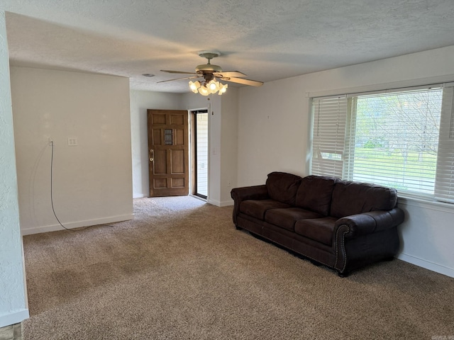 62 Ruby Ln, Melbourne, AR 72556 - living area featuring a textured ceiling, carpet flooring, baseboards, and a ceiling fan