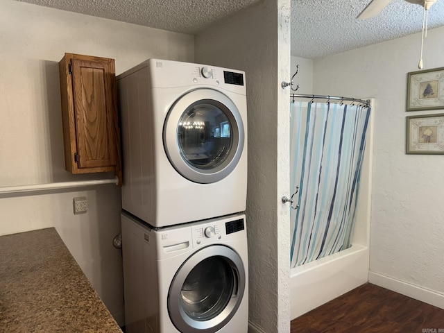 62 Ruby Ln, Melbourne, AR 72556 - laundry room featuring stacked washer and clothes dryer, dark wood-style floors, laundry area, and a textured ceiling