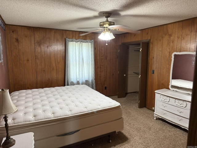 62 Ruby Ln, Melbourne, AR 72556 - carpeted bedroom with a textured ceiling, a closet, wood walls, and ceiling fan