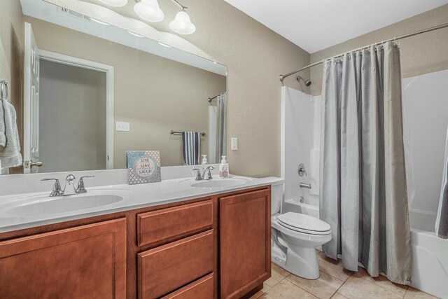 bathroom with tile patterned floors, shower / bathtub combination with curtain, a sink, and visible vents