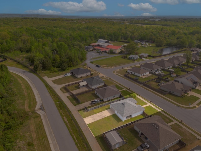 bird's eye view featuring a forest view and a residential view