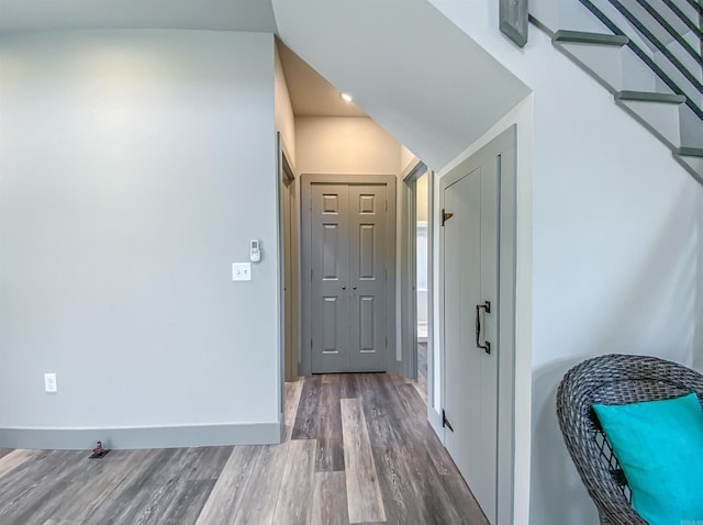 hall featuring wood finished floors and baseboards