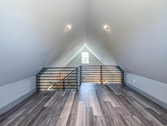 bonus room with vaulted ceiling, baseboards, and wood finished floors