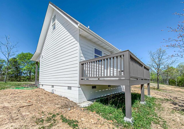 view of home's exterior with crawl space and a wooden deck