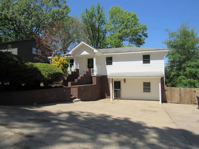 ranch-style home featuring brick siding and fence