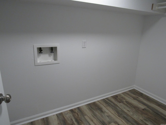 laundry area with dark wood-style flooring, baseboards, laundry area, and washer hookup