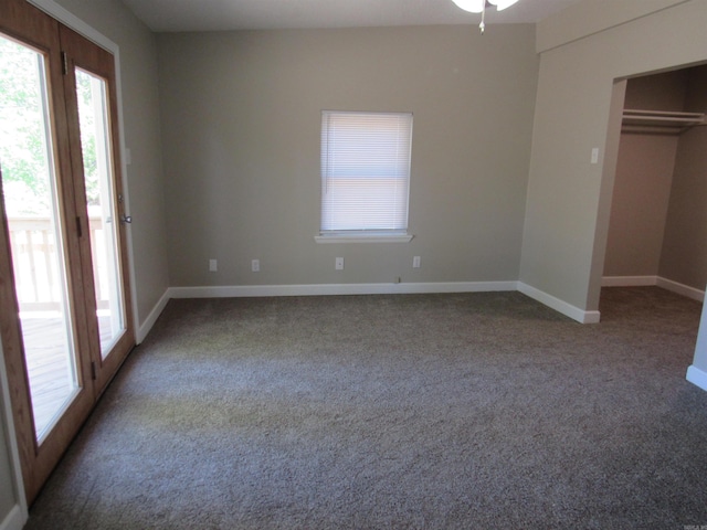 unfurnished bedroom featuring a closet, baseboards, access to outside, and carpet