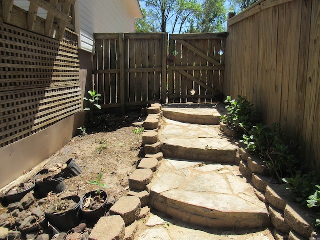 view of yard featuring fence and a gate