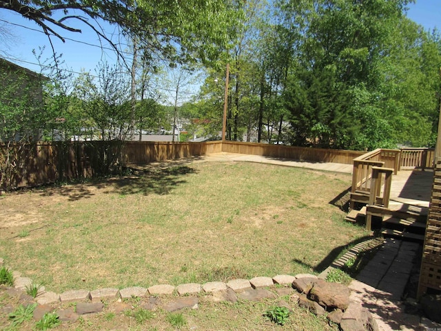 view of yard with a fenced backyard and a wooden deck