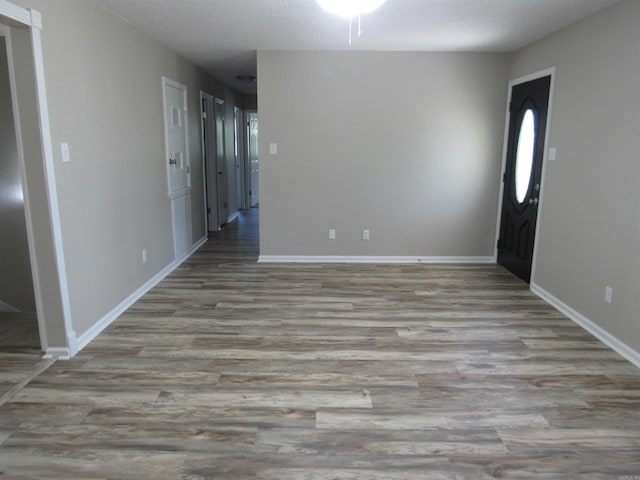 interior space featuring baseboards and wood finished floors