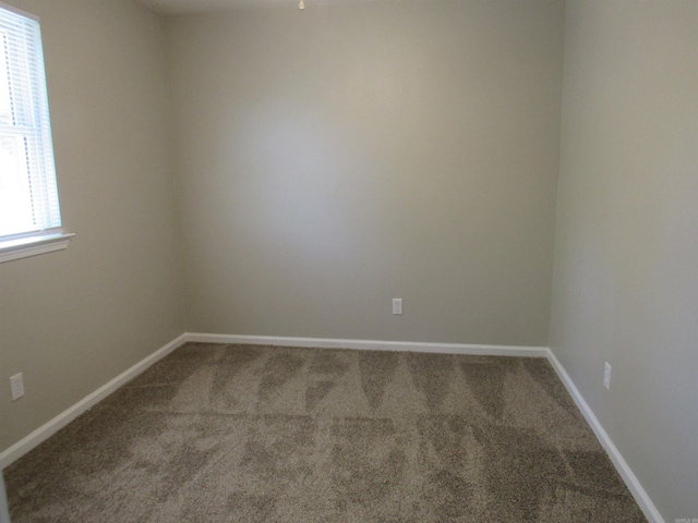 unfurnished room featuring carpet flooring and baseboards