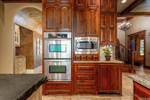 1130 Applewood Dr, Conway, AR 72034 - kitchen with baseboards, an inviting chandelier, beam ceiling, stainless steel appliances, and light stone counters