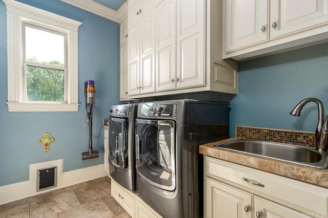 1130 Applewood Dr, Conway, AR 72034 - laundry room featuring crown molding, independent washer and dryer, a sink, baseboards, and cabinet space