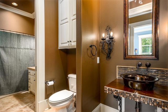 1130 Applewood Dr, Conway, AR 72034 - bathroom with a sink, ornamental molding, toilet, and baseboards