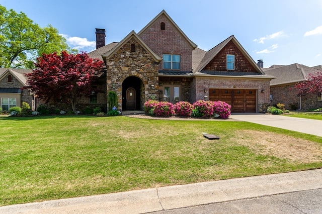 1130 Applewood Dr, Conway, AR 72034 - view of front of home with an attached garage, stone siding, a chimney, a front lawn, and driveway
