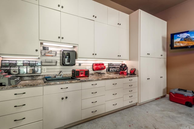 1130 Applewood Dr, Conway, AR 72034 - kitchen featuring a sink, stone counters, white cabinets, and concrete flooring