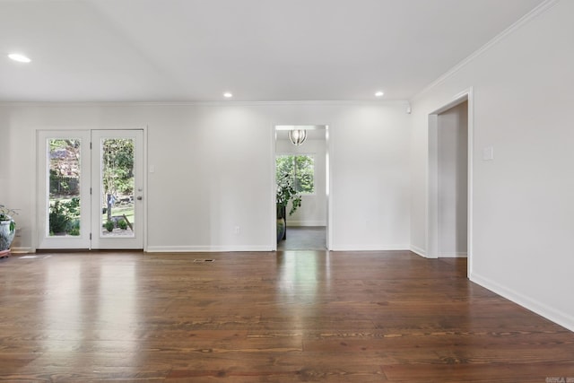 spare room featuring crown molding, wood-type flooring, baseboards, and recessed lighting