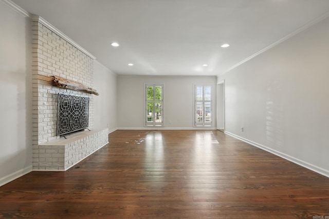 unfurnished living room featuring baseboards, ornamental molding, recessed lighting, a brick fireplace, and wood-type flooring