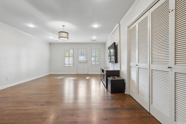 entrance foyer with dark wood-style flooring, ornamental molding, baseboards, and recessed lighting