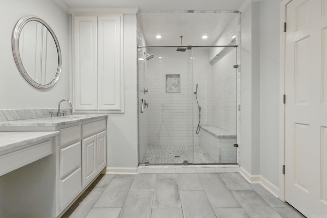 full bathroom with baseboards, a shower stall, vanity, and recessed lighting