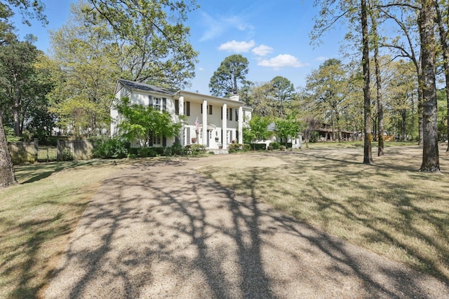 exterior space featuring a front yard and fence