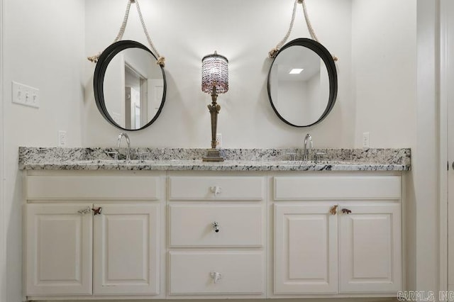 bathroom featuring double vanity and a sink